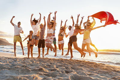 Teenagers jumping on a beach